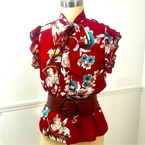 Red flower print ruffled sleeveless blouse with large bow tie at neck